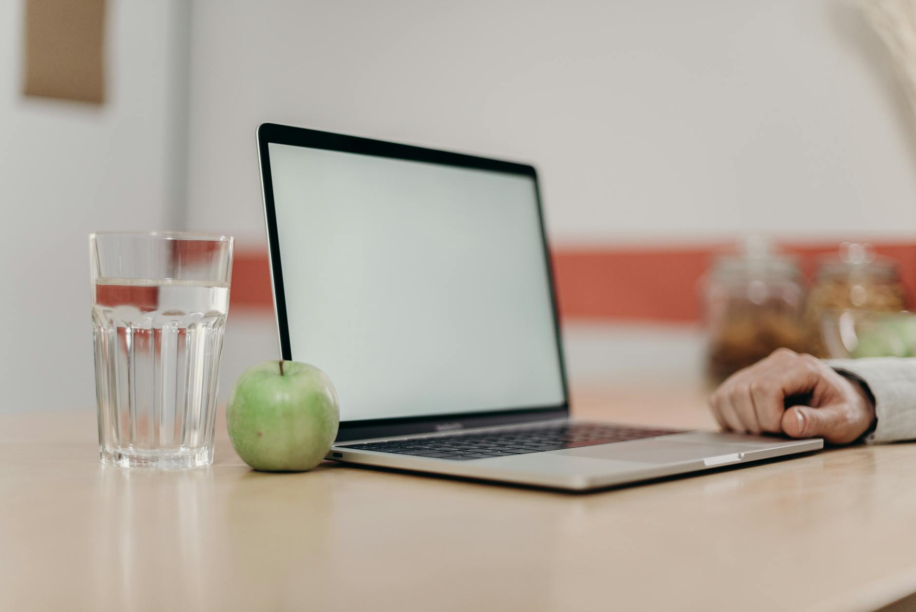 green apple fruit beside black tablet computer on brown wooden table