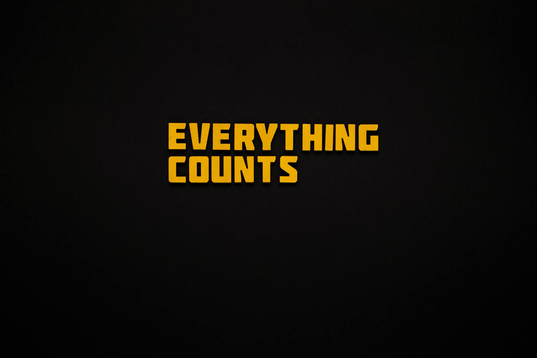 yellow message everything counts against a black background