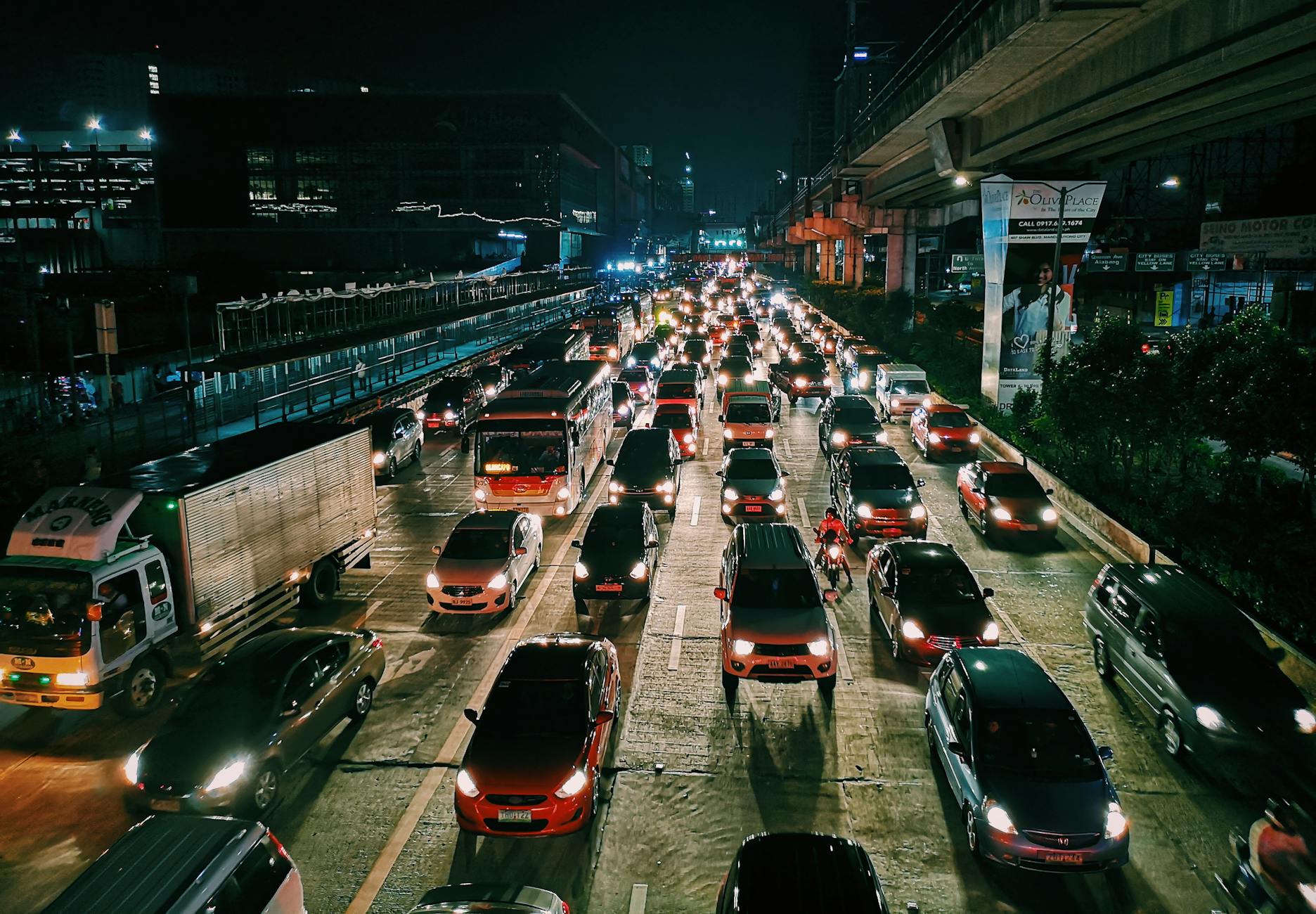 photo of vehicles on road during evening