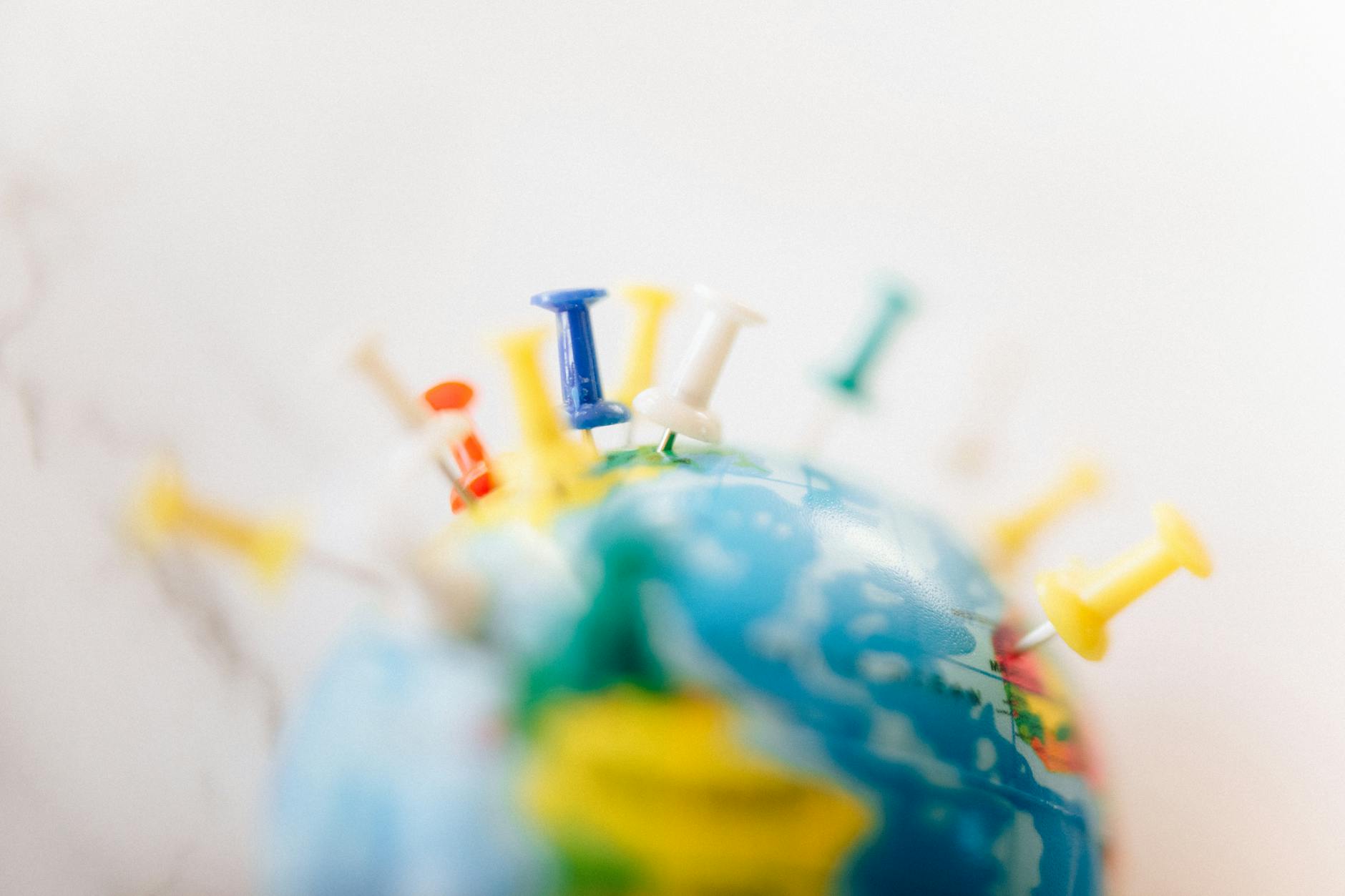 a globe with push pins