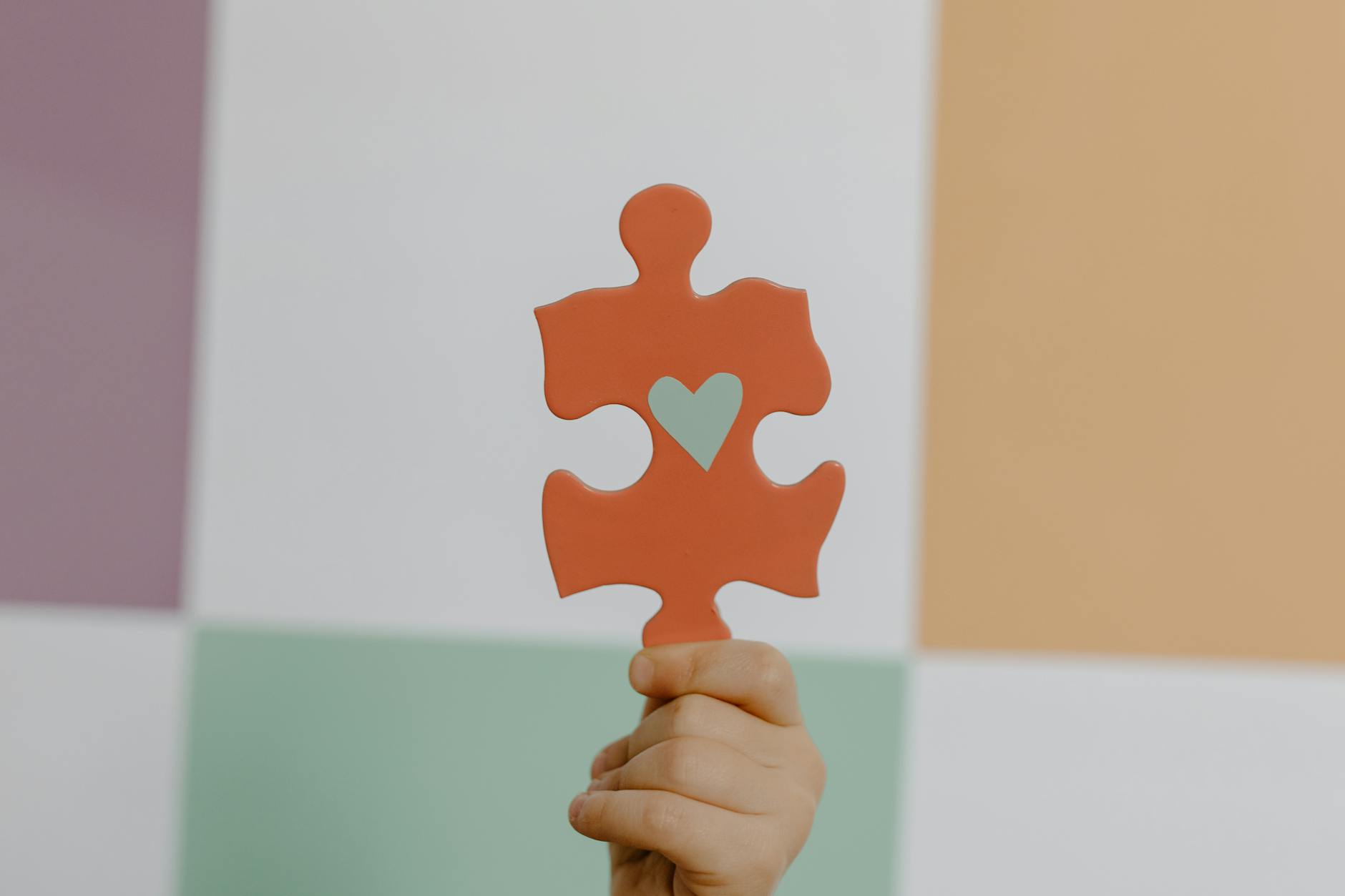 person holding orange puzzle piece