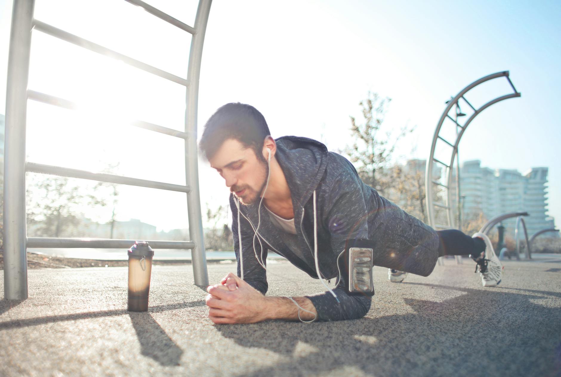 young determined man training alone on street sports ground in sunny day